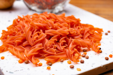 Vegan gluten free and vegetarian food, dried spiral pasta made from orange lentils legumes
