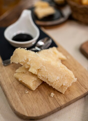 Tasting of different matured and very old parmesan Parmigiano-Reggiano hard cheese and balsamic vinegar of Modena in Parma, Emilia Romagna, Italy