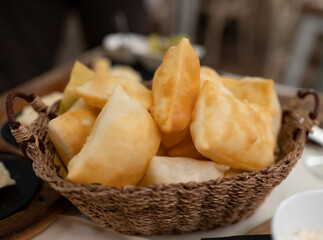 Food of Emilia Romagna region, deep fried bread gnocco fritto or crescentina served in restaurant in Parma, Italy