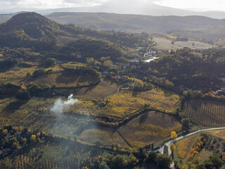 Naklejka premium Aerial view on hills witn vineyards near old town Montepulciano, Tuscany, Italy