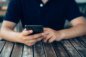 Closeup businessman hands touch screen on smart phone, marketing technology and business concept.