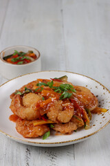Udang saus asam manis or Sweet and sour prawns, made from fried prawns with tomato sauce.