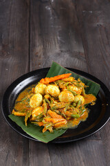 Telur Puyuh Acar Kuning or quail eggs with Pickled Vegetables, Indonesian traditional cuisine