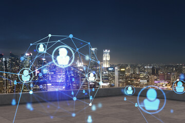 Rooftop with concrete terrace, Singapore night skyline. Recruitment process to hire candidates for...