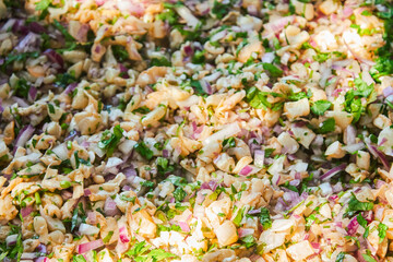 Traditionally made Mexican ceviche. Fish strips with tomato, lettuce, onion, avocado, orange.