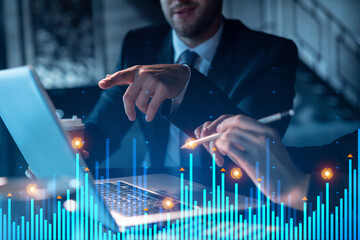 Two colleagues in formal wear working together to optimize trading strategy at corporate finance fund. Forex chart hologram over modern office background