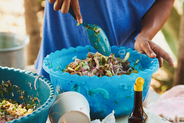 Traditionally made Mexican ceviche. Fish strips with tomato, lettuce, onion, avocado, orange.