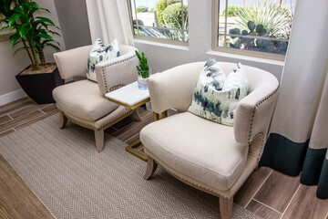 Two U-Shaped Arm Chairs With Decorator Pillows