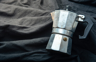 Mocha Pot Italian Street Coffee Maker long time old on a black cloth.moka Italian pot Moka pot stainless steel coffee machine