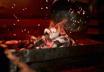 Theres nothing like the smell of a charcoal grill being fired up. Closeup shot of charcoal burning...