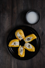 Ketan nangka or Sticky rice in jackfruit topped with coconut milk and sesame seeds,Thai dessert.