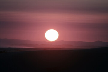 Sunset over desert dunes
