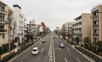 A view of a 3 lane road in Tokyo, Japan.