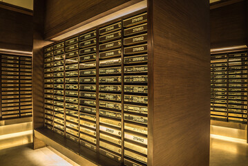 Mailboxes in apartment postal room with warm light decoration. Communication concept.