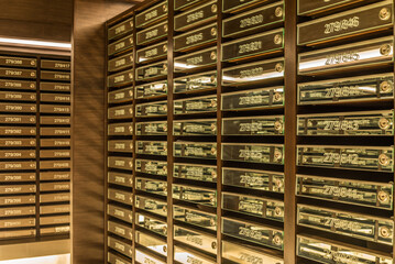 Mailboxes in apartment postal room with warm light decoration. Communication concept.