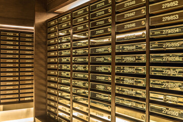 Mailboxes in apartment postal room with warm light decoration. Communication concept.