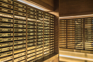 Mailboxes in apartment postal room with warm light decoration. Communication and business concept.