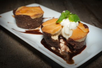 Curd sweet chocolate muffins on a plate with jam on wooden table.Curd sweet chocolate muffins on a plate with jam on wooden table...