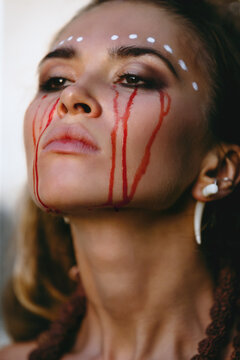 Portrait of a female crying with a tear of blood