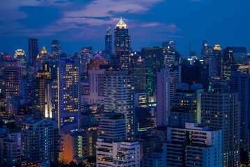 Fototapeta na wymiar Night cityscape of modern capital Bangkok city, Thailand in twilight evening. Building, architecture and city concept.