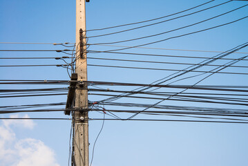 Electric pole transmission power line with blue sky background. Electrical energy and technology...