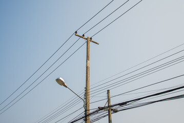 Electric pole transmission power line with blue sky background. Electrical energy and technology...