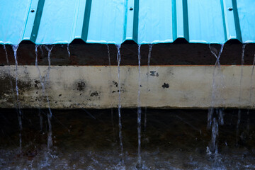water drops on green corrugated metal roof	
