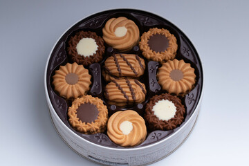 Assorted cookies set in a round box on white background for the new year.