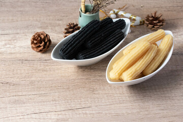 churros sticks typical of Spain with charcoal and vanilla