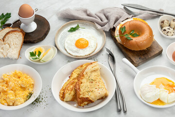 Various ways of cooking chicken eggs on light background.