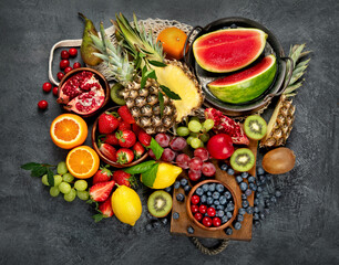 Delicious raw fruit on dark background.