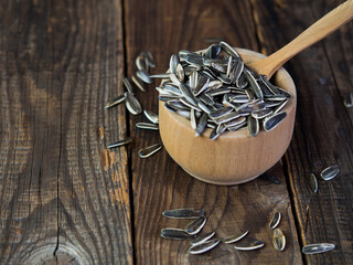  Unpeeled sunflower seeds on an old wooden table