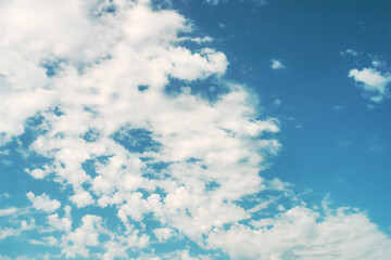 Blue sky, white clouds with yellow spots