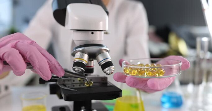 Scientist conducts laboratory research on omega 3 capsules