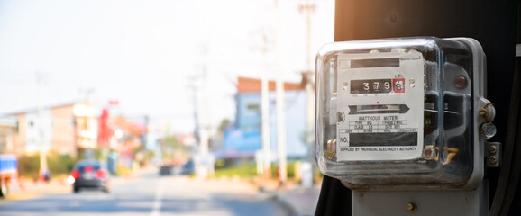 Watthour meter of electricity hung on the cement pole beside the road to monitor and measure power...
