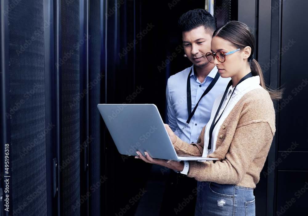 Poster No one knows networking like they do. Shot of two technicians working together in a server room.