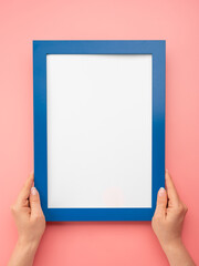 Woman hold blank diploma frame on pink wall background. empty mockup frame. Holding frame mockup....