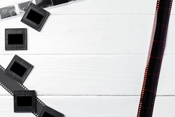 Old vintage film, slides and photos on white wooden background