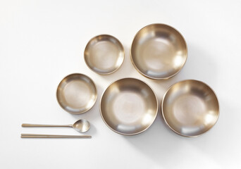 Korean high quality brass tableware with chopsticks isolated on white background. Top view. 
