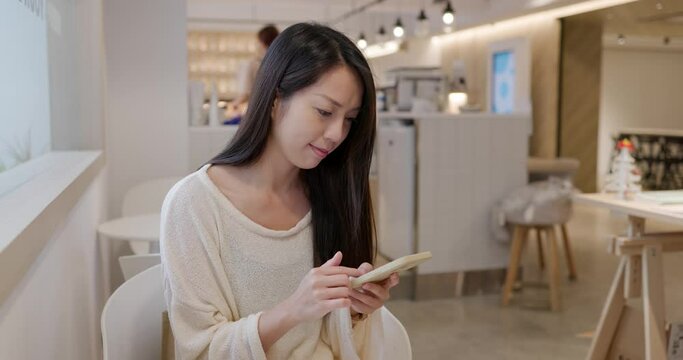 Woman use mobile phone in coffee shop