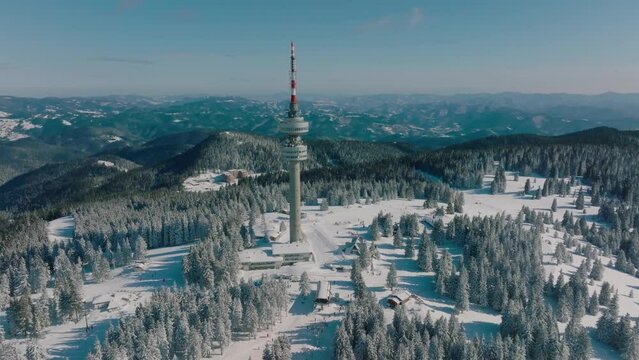 4K Aerial winter view of Rhodope Mountains and Snezhanka tower near resort of Pamporovo, Smolyan Region, Bulgaria