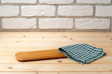 Cutting board with cotton napkin on wooden table