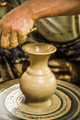 Old Thai man making pottery to perform in Thai traditional festivals at Koh Kret Nonthaburi Province, Thailand