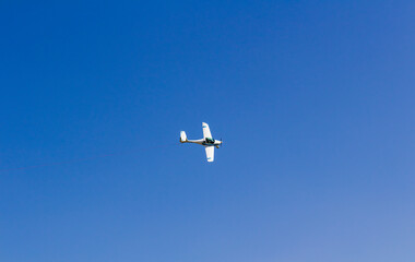 Ultra light, cessna plane from above with prolonge rope on blue sky. Sport, transportation...