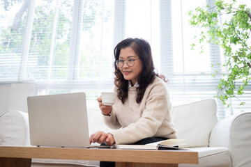 Image of senior Asian businesswoman working at home