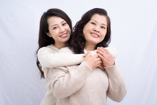 Portrait of Asian mother and daughter on white background