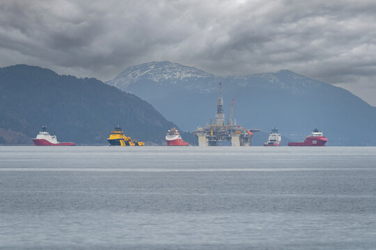 Hareid, Norway - 2022 March 27. Rig move of Equinor oil platform Njord Alpha with ahts vessels, Siem Pearl, Siem Opal, Skandi Vega, Magne Viking and Normand Prosper. 