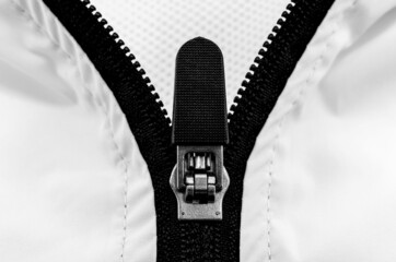 Lock with black zipper on white clothes. Jacket clasp © Gudman
