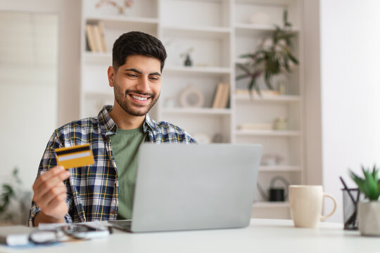 Smiling Young Man Using Pc And Credit Card, Selective Focus