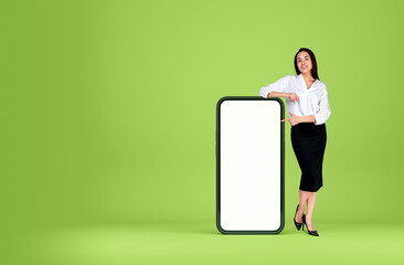 Businesswoman point at phone mockup display on bright background